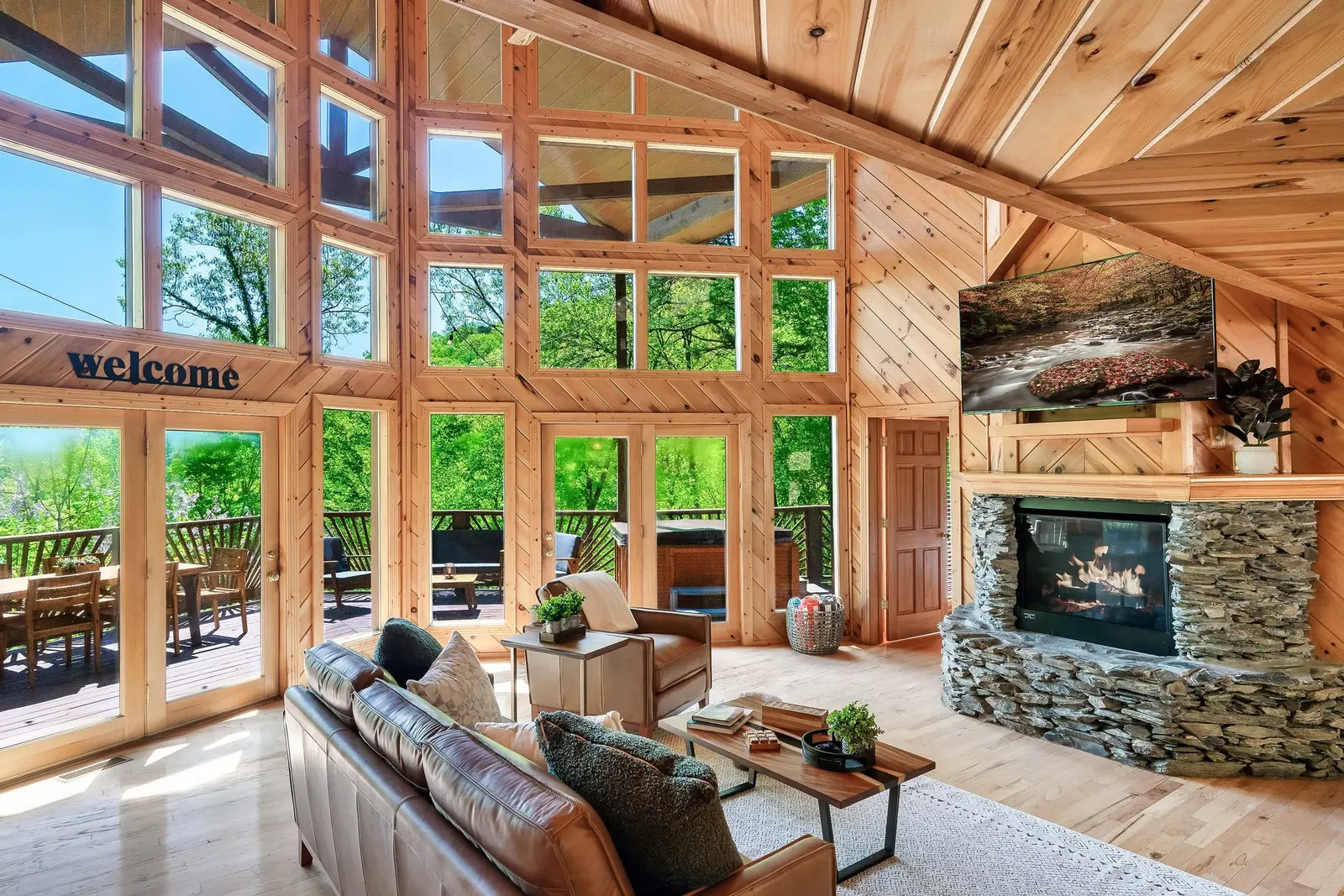 Open living room with timber ceilings and stone fireplace